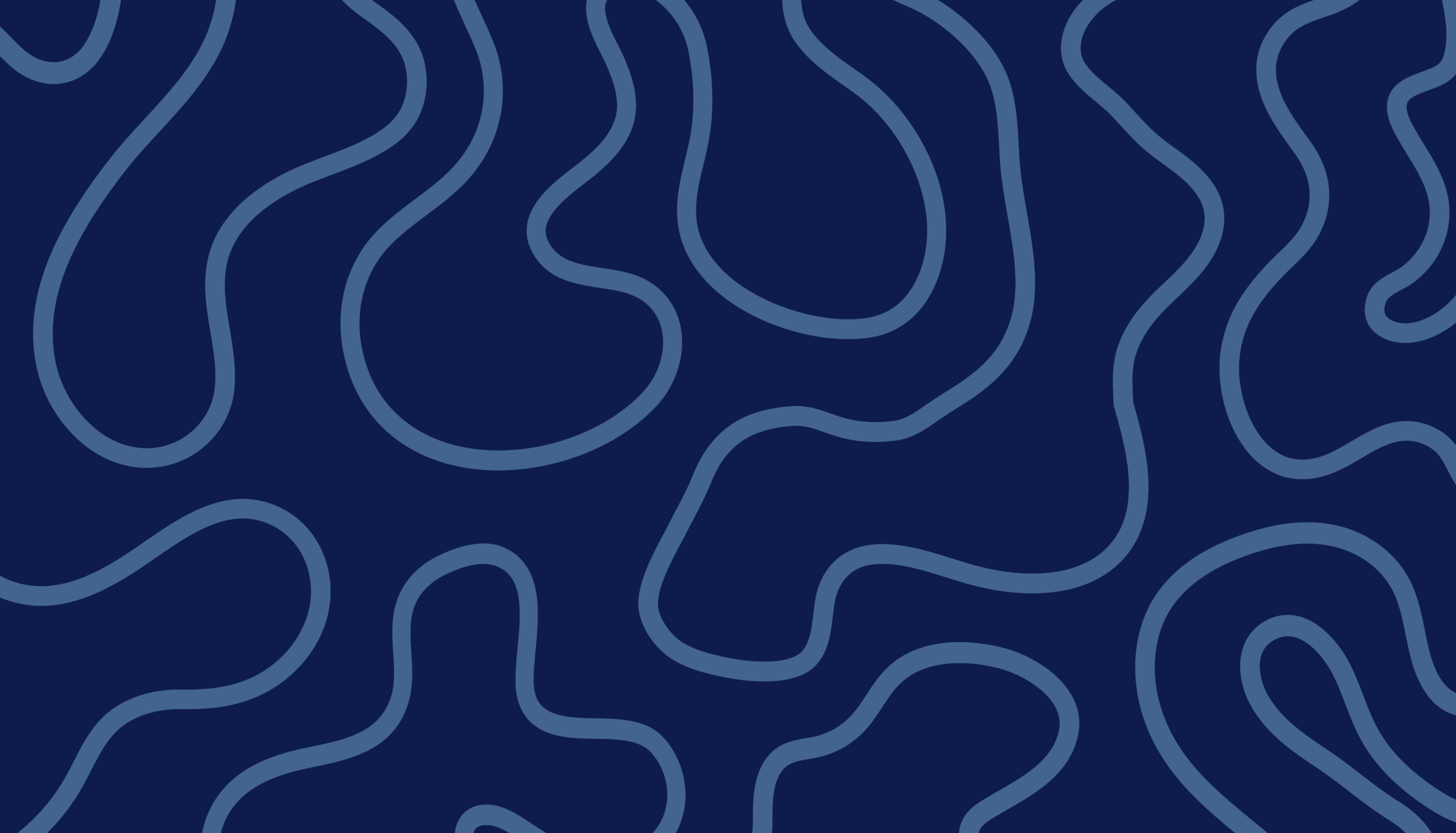 A person stands near the Eiffel Tower at night, with colorful lights illuminating the metal structure against the deep blue sky.